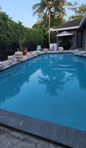 Art Lego LLC pool deck remodel with natural stone pavers — South Florida